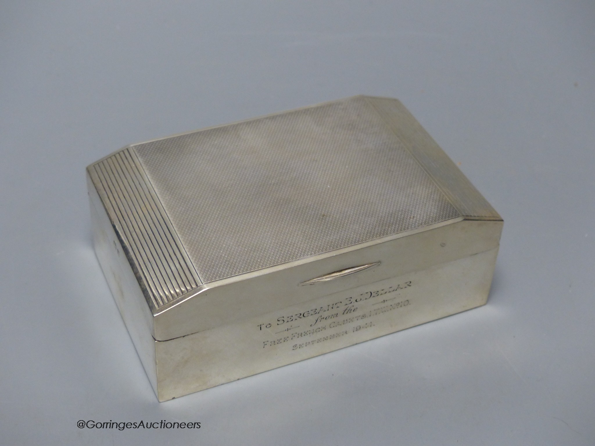 A George VI silver cigarette box, with military related inscription, Birmingham, 1939, 13.7cm, gross weight 14oz.